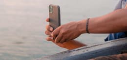 man taking a photo of sunset with iphone
