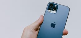 person holding refurbished iphone 12 pro pacific blue
