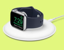The Apple Watch SE 3 placed on a magnetic charger.