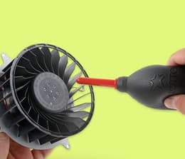 Close-up image of canned compressed air next to PlayStation 5 air vents.