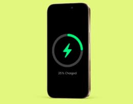 An iPhone 16 Pro Max plugged into a charger