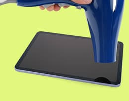 An image of a hair dryer being held above an iPhone