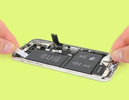 Close-up of an iPhone battery showing the adhesive strip pull tabs