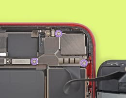 An image of an iPhone screen open with the front sensor and cover connector screw highlighted