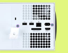 The back panel of the Xbox Series X with screws highlighted