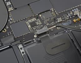 Close-up of inside of a MacBook Pro showing the trackpad cable bracket