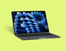 Apple MacBook Air 15-inch M3 (2024) open on a desk with a creative workspace setup.