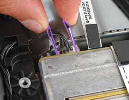 An Xbox Series X interior with cooling fan screws and cable connector highlighted