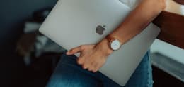 person holding used macbook pro