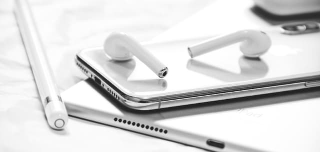 AirPods from Apple next to an iPhone